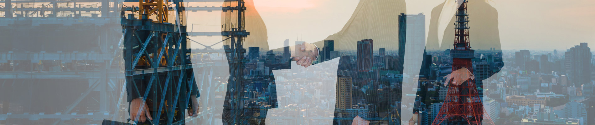 business people shaking hands superimposed over high rise construction